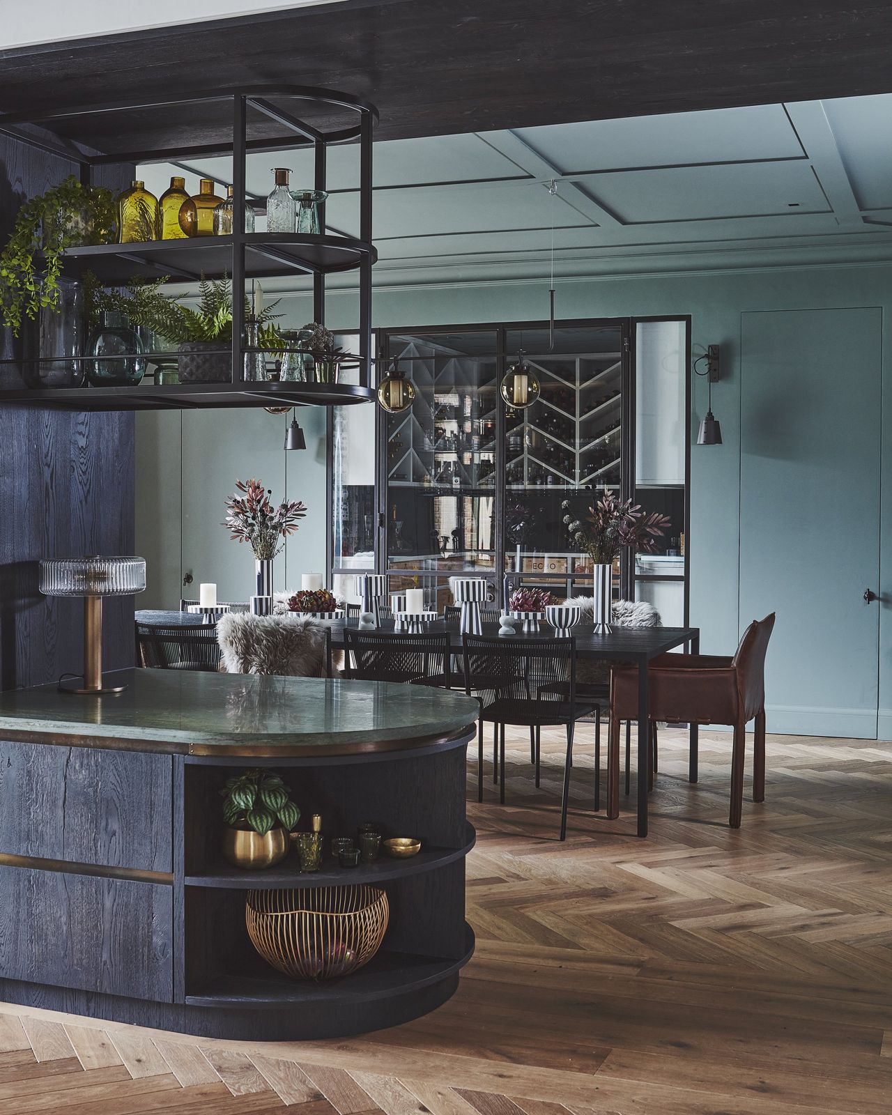 Dining room with a deep blue ceiling and dark joinery