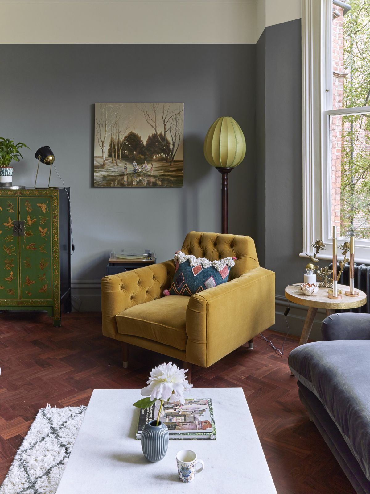 Sitting room with yellow armchair and layered textiles