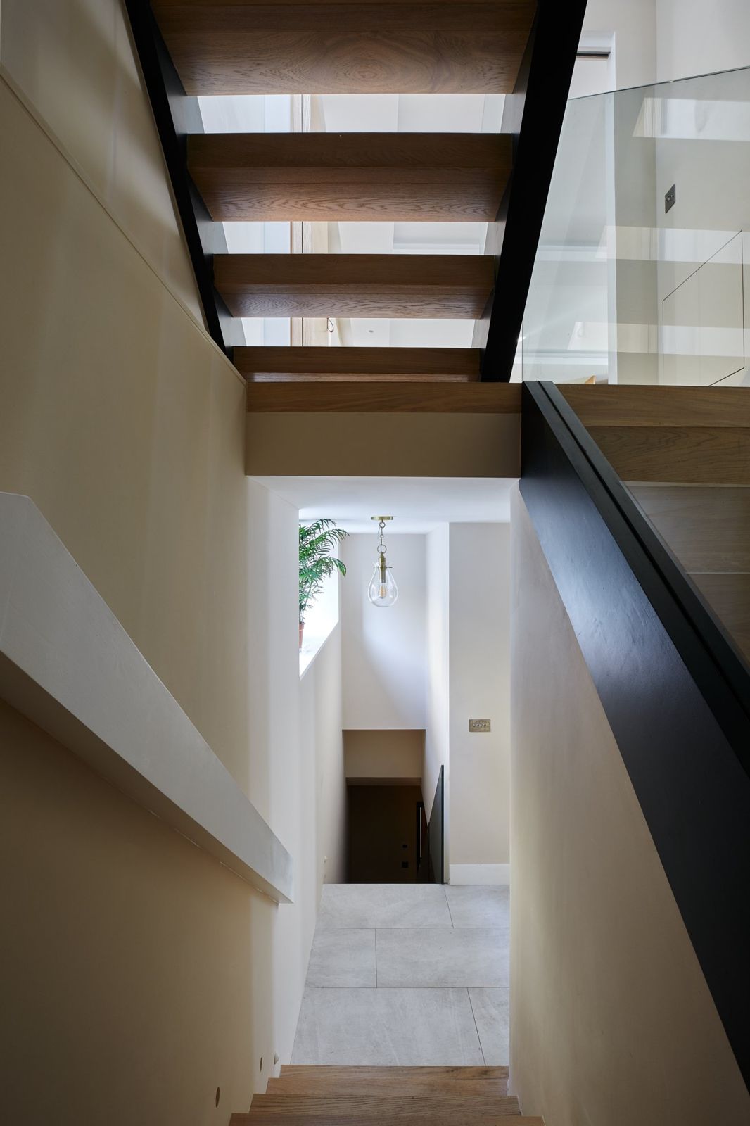 View down the stairwell through folded oak flights
