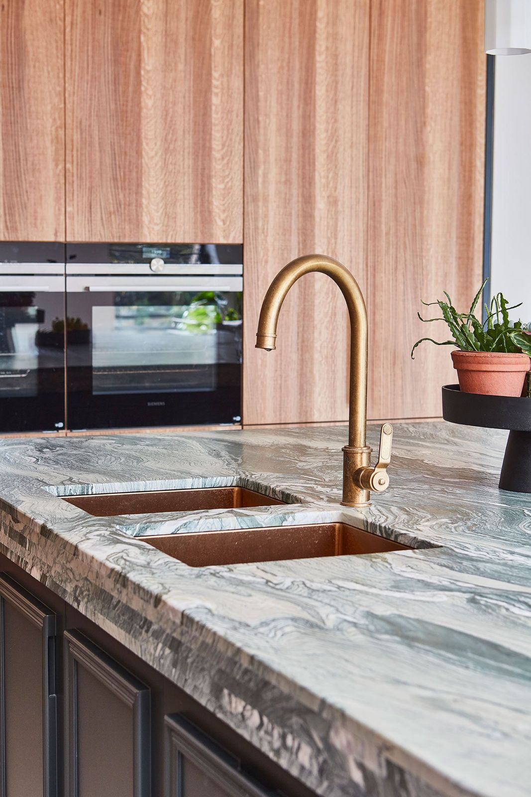 Cipollino marble worktop with copper sink and brass tap