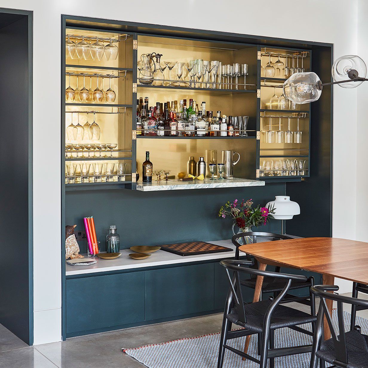 Drinks cabinet in dark joinery with illuminated glass shelving