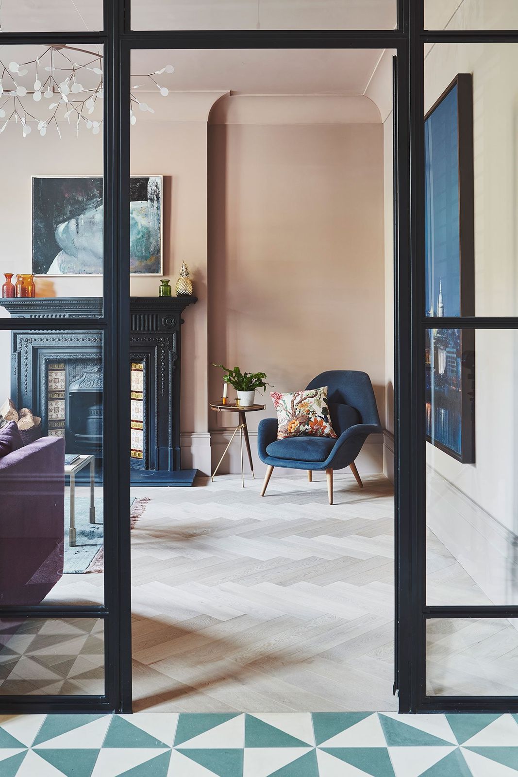 Pink-toned snug seen through a steel-framed glazed screen