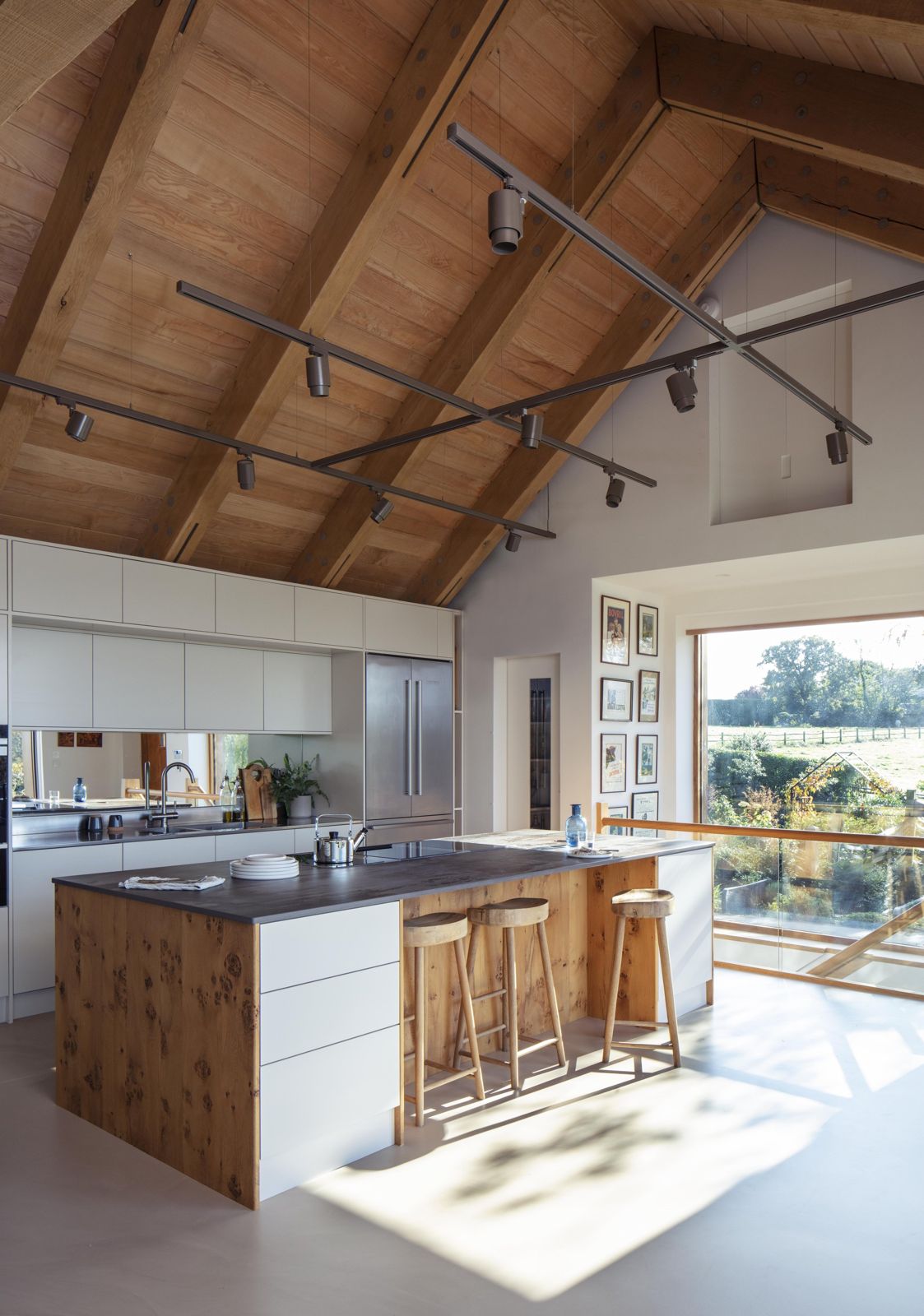 Vaulted kitchen with oak island beneath an exposed timber roof