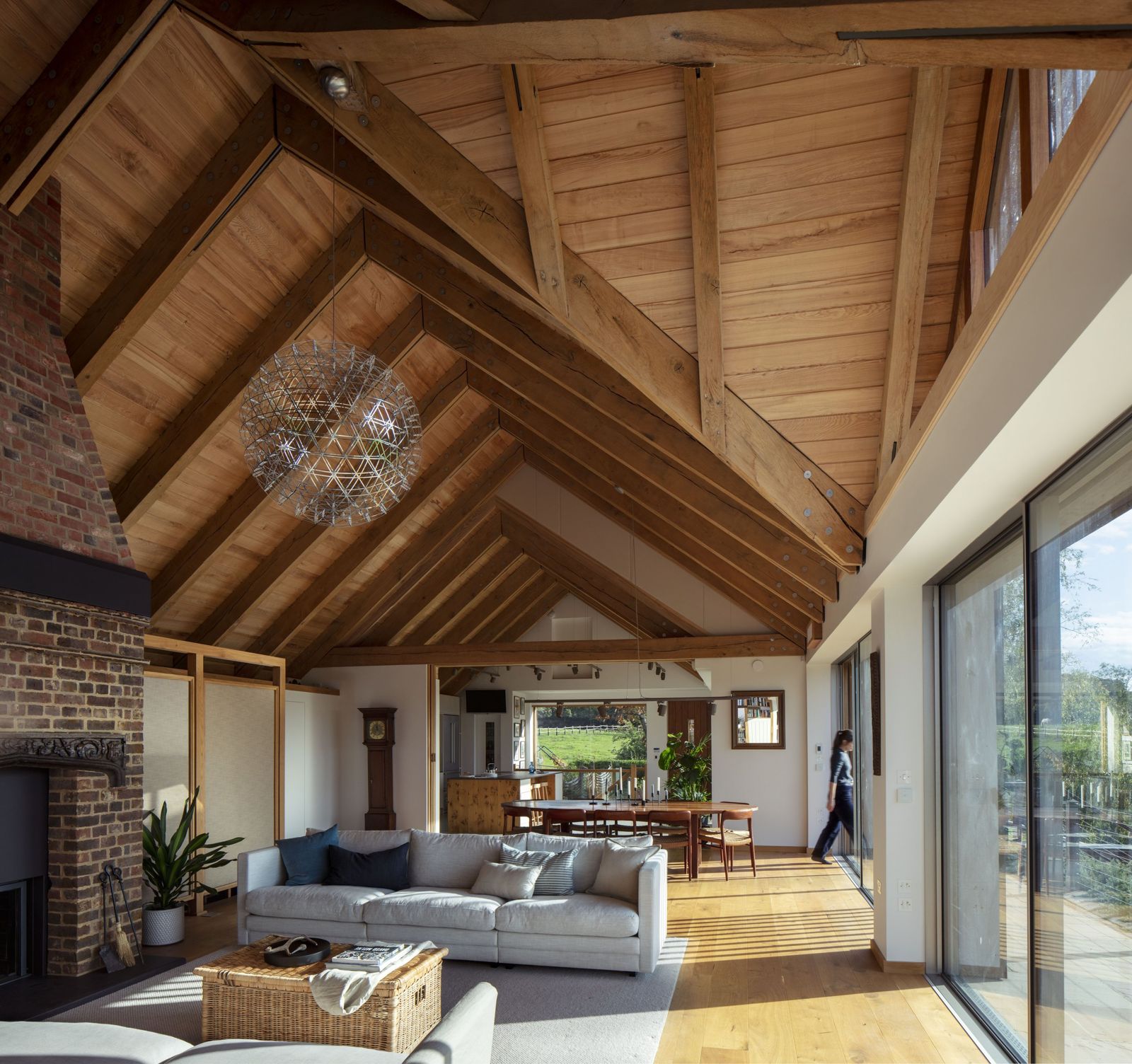 Sitting room with a log burner beneath the timber vault