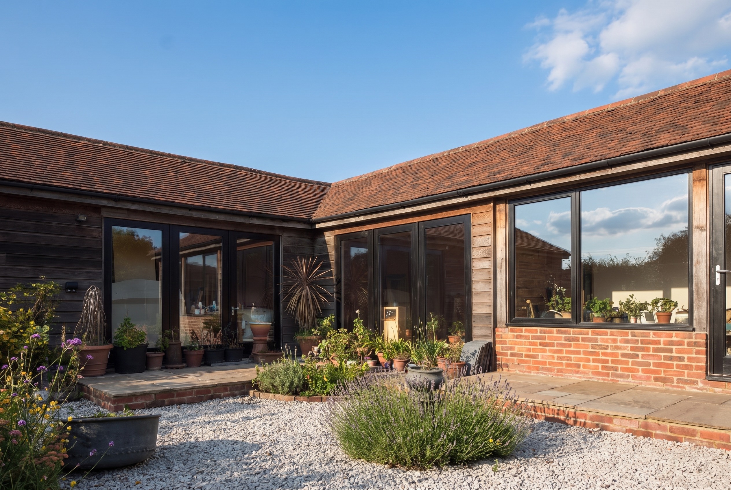 Garden courtyard with lavender and gravel against weathered timber cladding