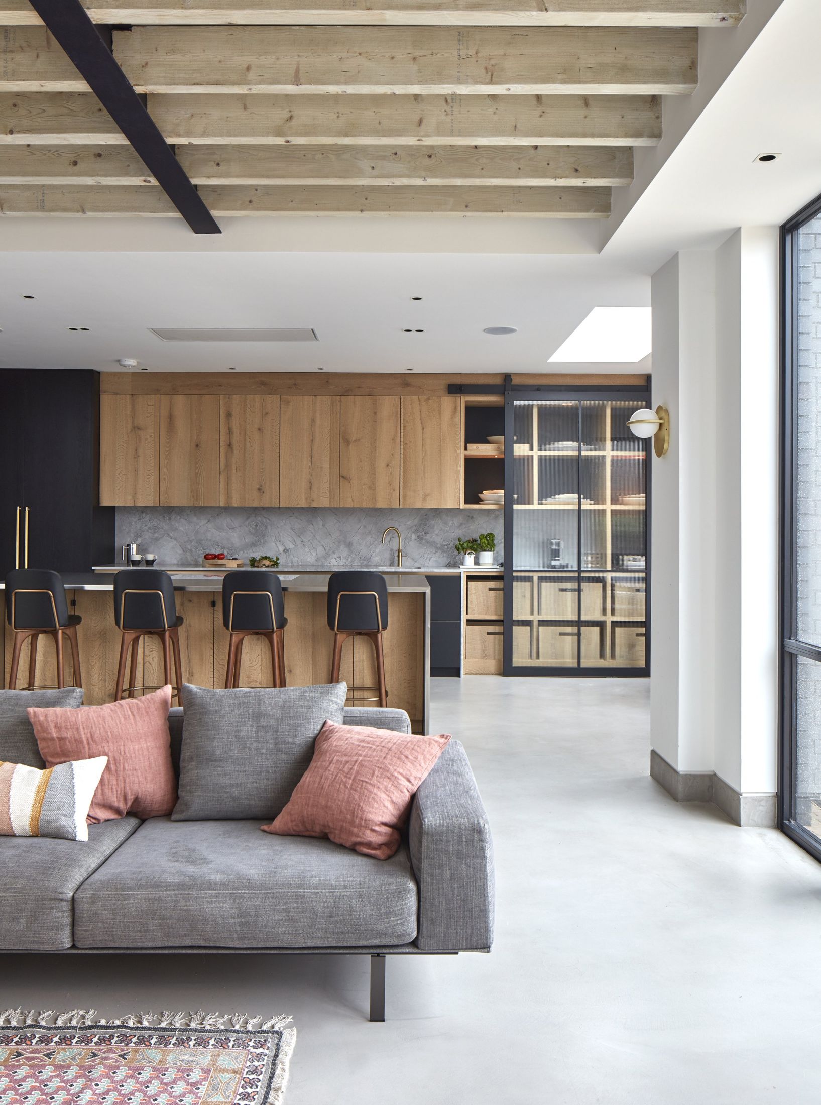 Oak kitchen and lounge with exposed joists and grey seating