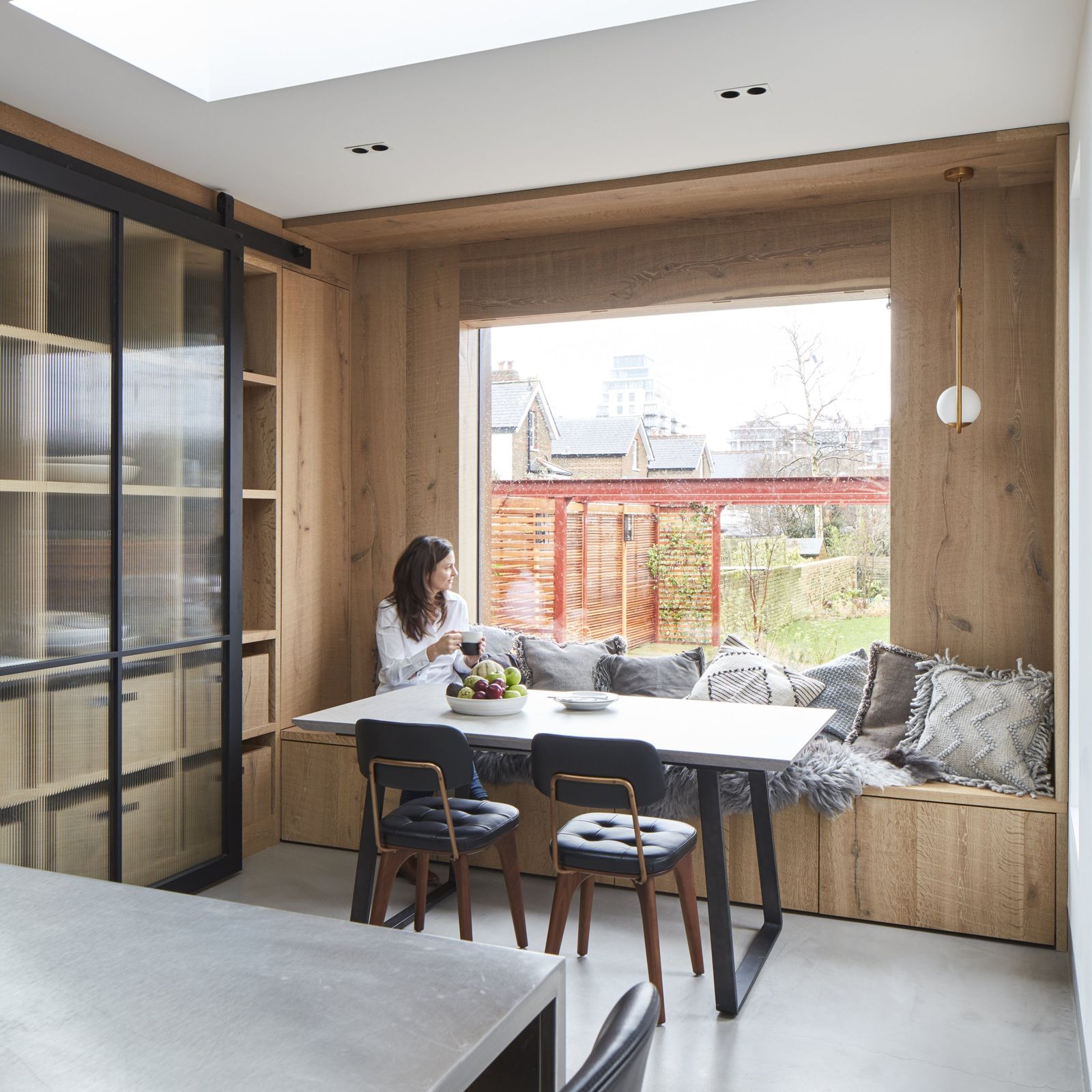 Dining nook with built-in window seat overlooking the garden