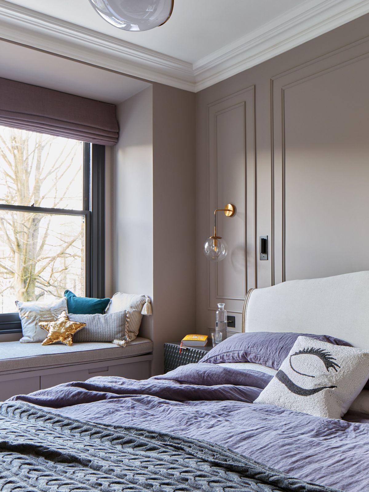 Calm bedroom in muted plaster tones with panelled joinery