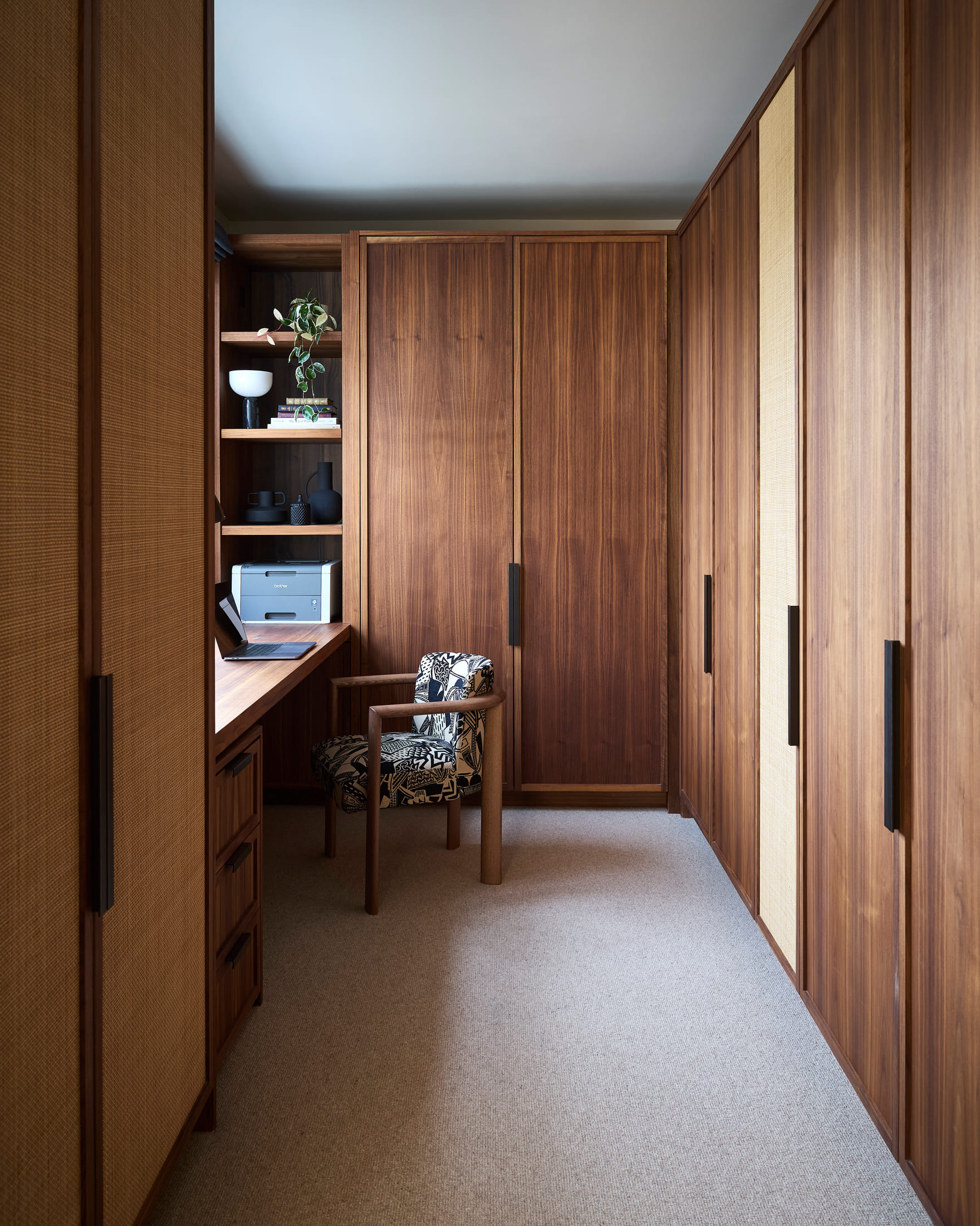 Dressing room in walnut and cane with a desk built into the window reveal