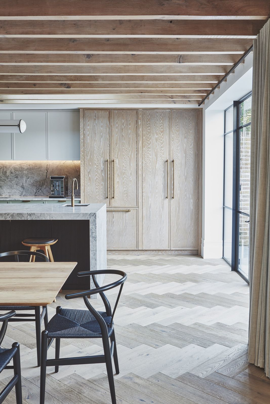 Pale kitchen with herringbone oak floor