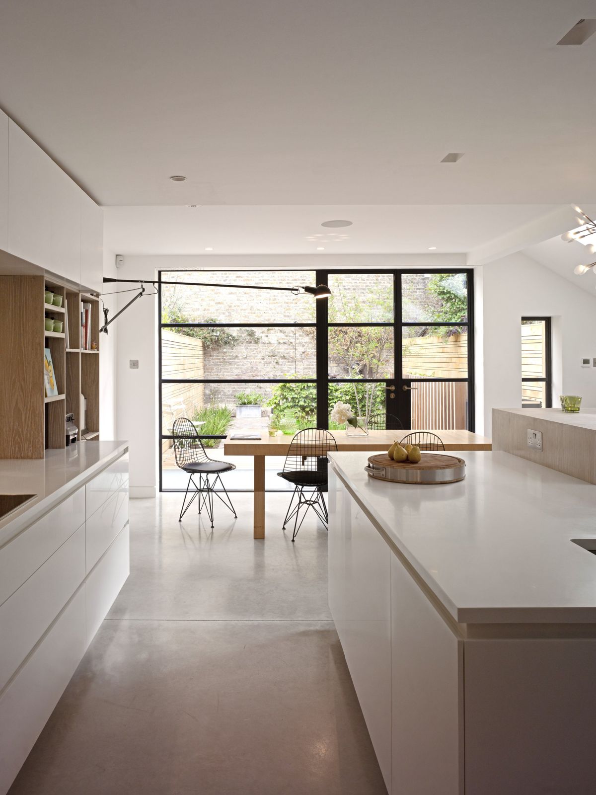 White kitchen with steel-framed glazing to the courtyard