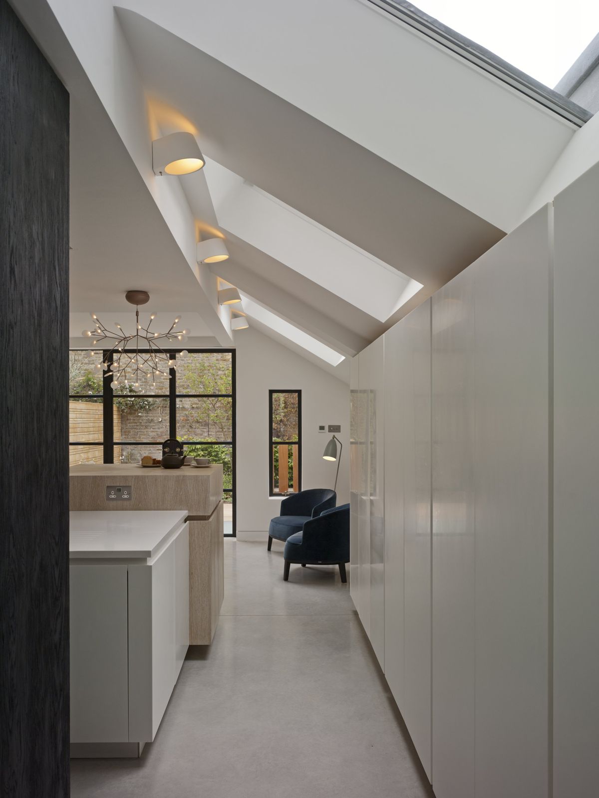 View through the kitchen to a blue reading chair