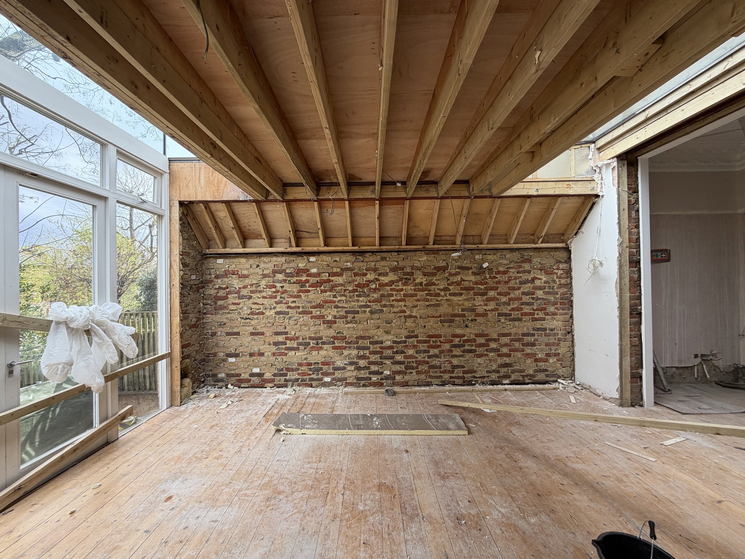 The old rear addition stripped to brick and exposed roof joists