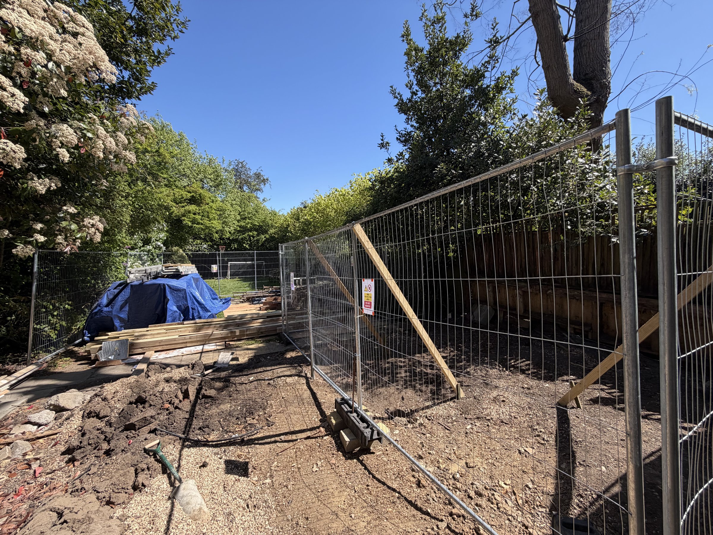 Tree protection fencing around the excavation area in the rear garden